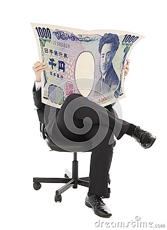 Business man sitting on a chair with japan currency Stock Photo