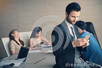 Business man smart and handsome standing using smartphone with t Stock Photo