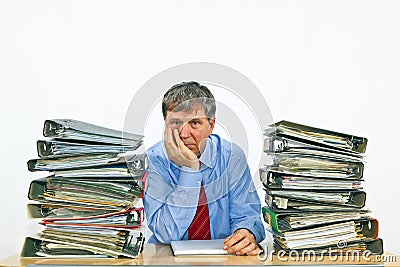 Business man with stacks of ring binders on his desk Stock Photo