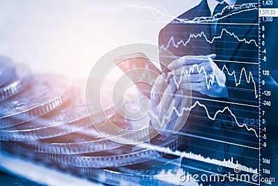 Business man on stock market financial trade indicator background. Man analysis stock market financial trade indices on LED. Stock Photo