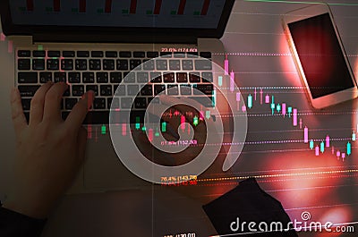 Business man or stock trader using laptop with stock graph chart by fibonacci indicator Stock Photo