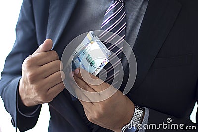 Business man in a suit concealing 100 soles bills, Peruvian currency concept Stock Photo