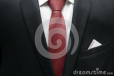 Business man in suit with jocker in the pocket of his jacket. Metaphor to confidence in winning. Businessman ready for risk and d Stock Photo