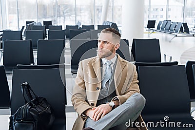 Business man with suitcase in hall of airport Stock Photo