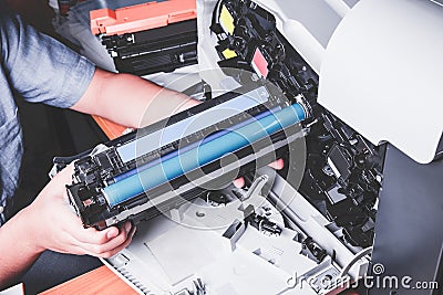 Business man or technician is checking and changing the printer equipment cartridges tone of laser jet multi function printer in Stock Photo
