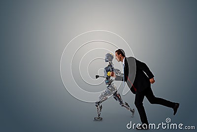 Business man try to make a compete, race, battle, fight with robot or artificial intelligence for fight for work, chance, job, opp Stock Photo