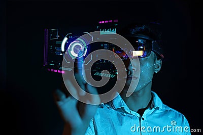 Business man try vr glasses hololens in the dark room | Young asian boy experience ar with glow earth globe on hand | Future Stock Photo