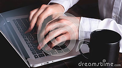 Business man typing on laptop keyboard while fingers and keys fuse - surreal Stock Photo