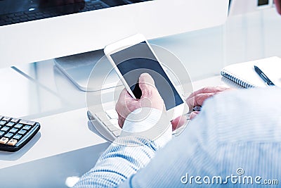 Business man typing on mobile device, office enviroment Stock Photo