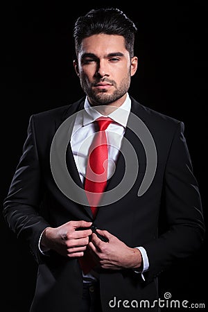 Business man unbuttons his jacket Stock Photo