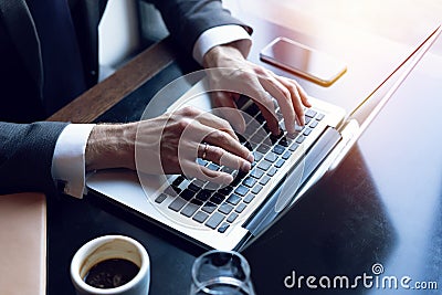 Business man using laptop computer. Male hand typing on laptop keyboard. Stock Photo