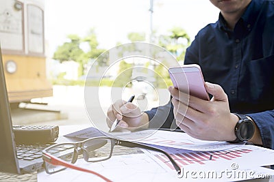 Business man using laptop and smartphone for analytic financial graph year 2017 trend forecasting planning outdoor pla Stock Photo