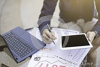 Business man using laptop and smartphone and tablet for analytic financial graph year 2017 trend forecasting planning outdoor pla Stock Photo