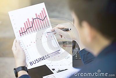 Business man using tablet for analytic financial graph year 2017 trend forecasting planning outdoor place Stock Photo
