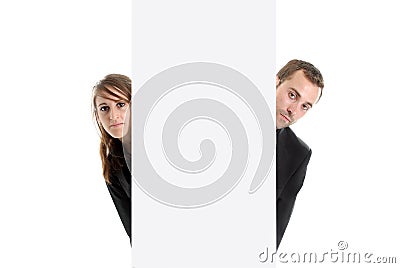 Business man & woman hiding behind an ad space Stock Photo