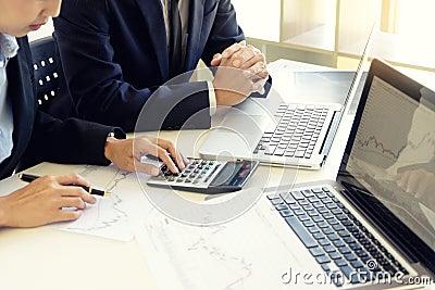business man and woman sit at ther table looking at computer laptop Stock Photo