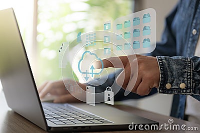 The Business man work with laptop seek data input and output from cloud data icon floating on screen Stock Photo