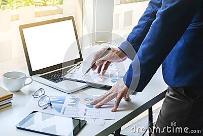 Business man working analysis data documents of stock market company at the office with blank screen laptop Stock Photo
