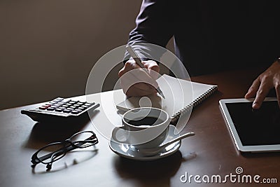 Business man working on digital tablet on wood table Stock Photo