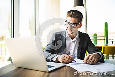 Business man working at office with laptop and documents on his desk. Stock Photo