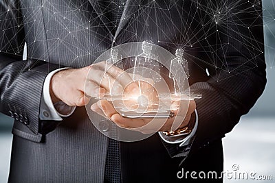 Businessman works with holograms of workers on a mobile device Stock Photo