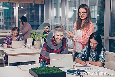 Business manager checking financial task of her colleagues. Smart clever intelligent colleagues discussing the new start up projec Stock Photo