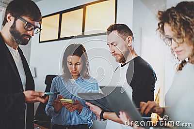Business meeting concept.Coworkers team working with mobile devices at modern office.Blurred background.Horizontal. Stock Photo