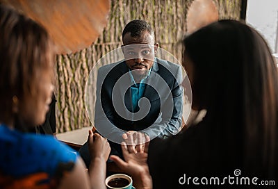 Business consultation by black african financial adviser and two business woman Stock Photo