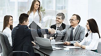 Business meeting the table and handshake of business partners Stock Photo