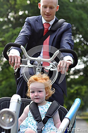 Business men riding his young child to creche Stock Photo