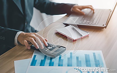 Business men use calculators to calculate business ratios. Evaluate your investment budget plan. Stock Photo