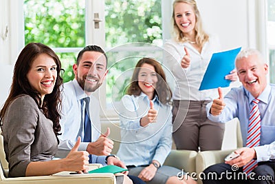 Business men and women in office having success Stock Photo