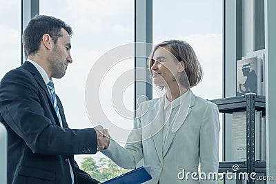 Business men and business women are standing hand in hand Stock Photo