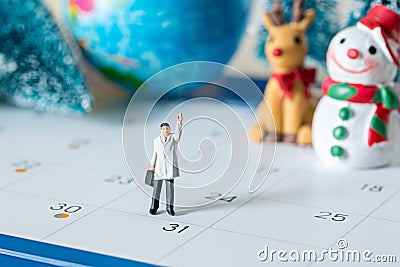 business miniature figures people on 31 day calendar and christmas ornamental background Stock Photo