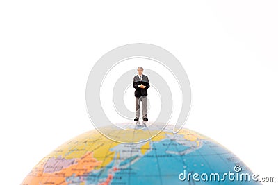 Business miniature people standing on the globe Stock Photo