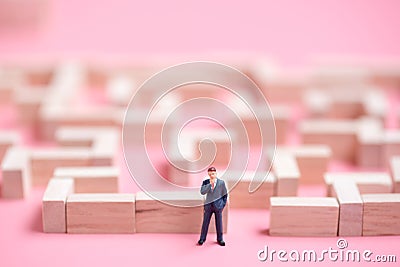 Business miniature at the start point of puzzle maze wood block Stock Photo
