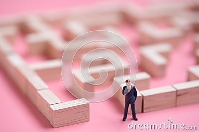 Business miniature at the start point of puzzle maze wood block Stock Photo