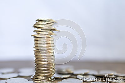 Business, Money, Finance, Security and Saving Concept. Close up of unstable stack of coins on wooden table with copy space Stock Photo