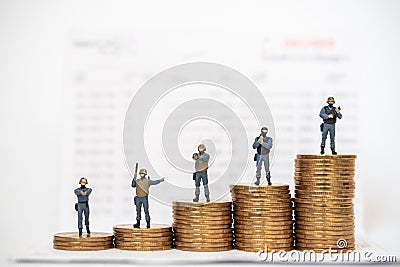 Business, Money Security Concept. Group of special operations soldiers miniature figure people with guns and weapons on top of Stock Photo