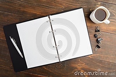 Business morning; notebook and coffee on brown wooden table Stock Photo
