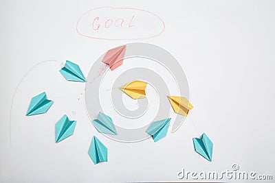 Business motivation, achieving goal and dream: The red plane of the paper escaping from the group Stock Photo