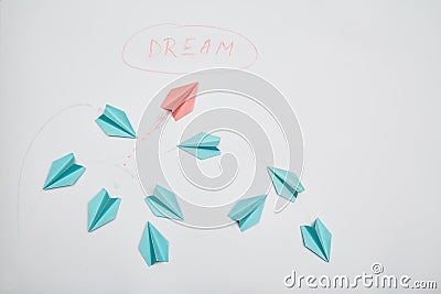 Business motivation, achieving goal and dream: The red plane of the paper escaping from the group Stock Photo