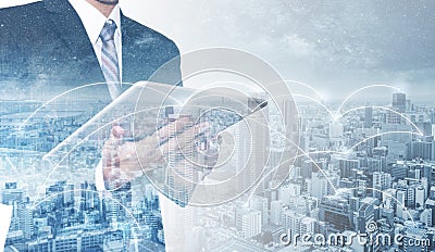 Business network, blockchain technology and internet connection. Double exposure businessman using digital tablet, and cityscape Stock Photo