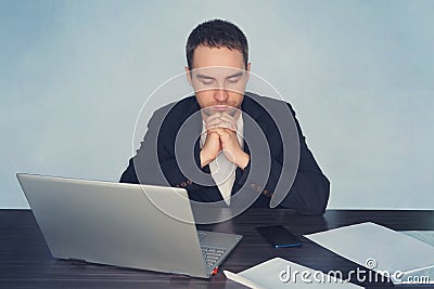 Business, overwork, people, deadline and technology concept - stressed businessman with laptop computer thinking at office. a man Stock Photo