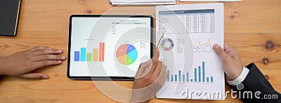 Business partner analysing business chart on digital tablet and paper work Stock Photo