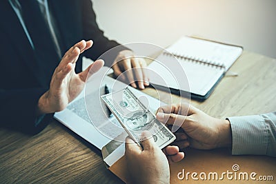 Business partners submit fraudulent cash to entrepreneurs whose male businessmen refuse to accept bribes in the office Stock Photo