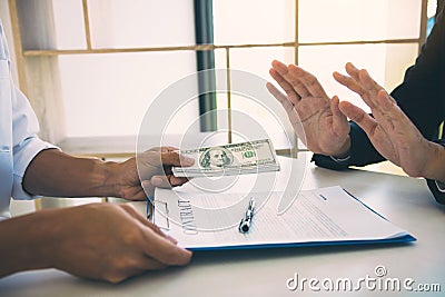 Business partners submit fraudulent cash to entrepreneurs whose male businessmen refuse to accept bribes in the office Stock Photo