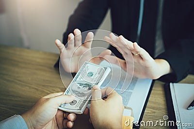 Business partners submit fraudulent cash to entrepreneurs whose male businessmen refuse to accept bribes in the office Stock Photo