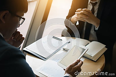 Business partnership coworkers using a tablet to chart company financial statements report and profits work progress and planning Stock Photo