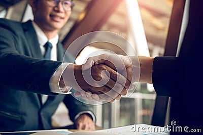 Business people accept or confirm project on the proposal and join shaking hands at office room company Stock Photo